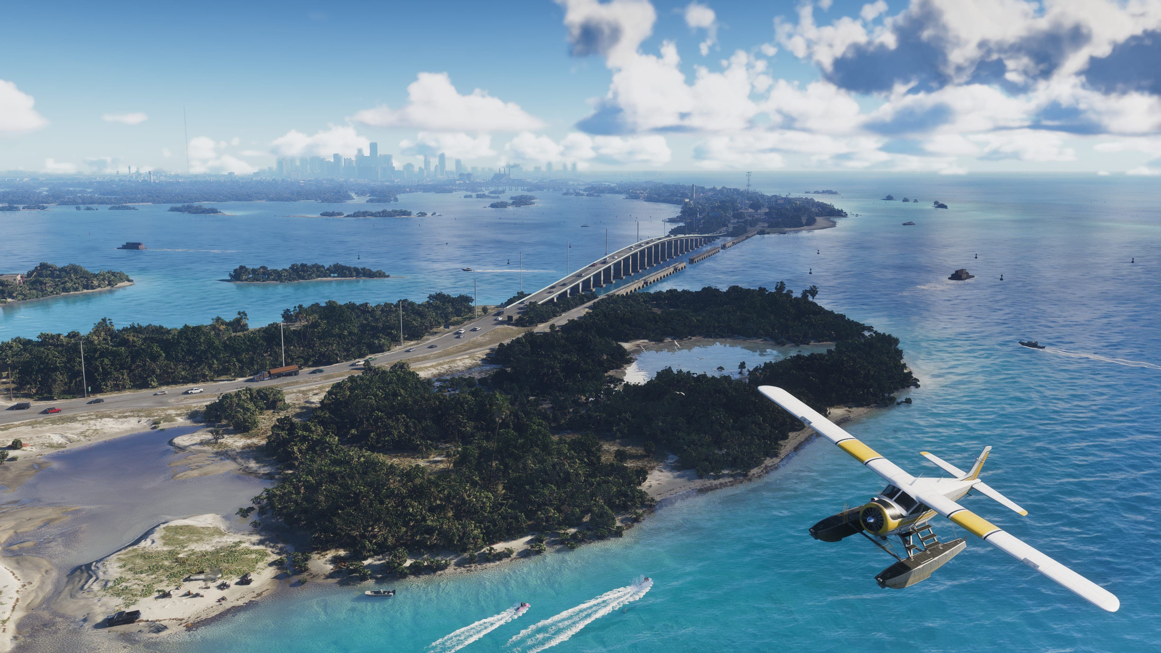 A white and yellow seaplane flies over the Leonida Keys, with a long bridge and the Vice City skyline in the distance
