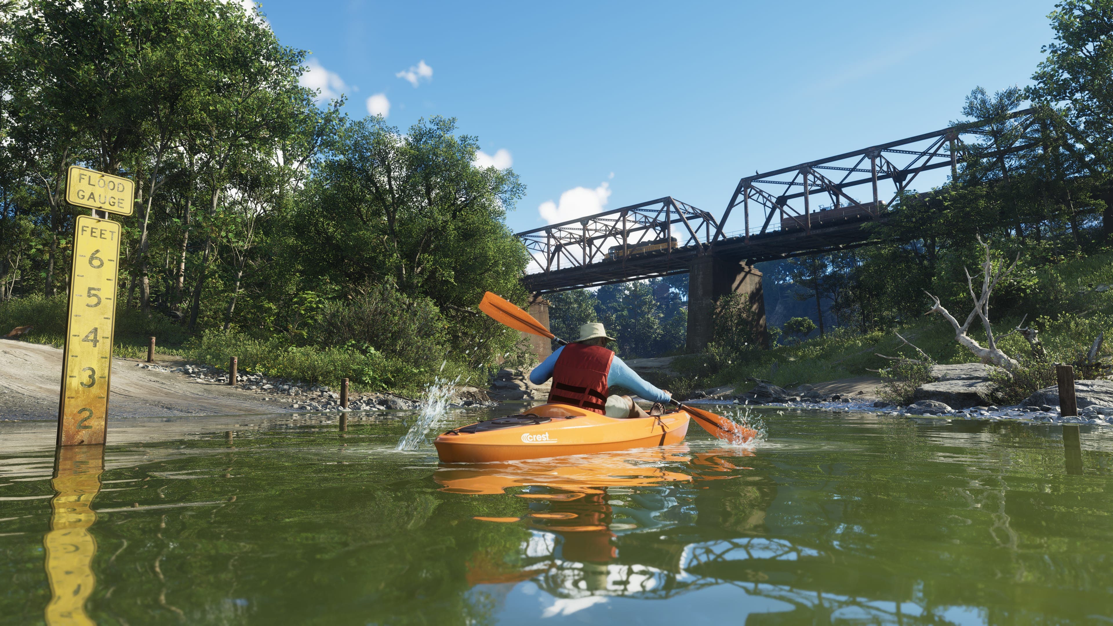 A kayaker in a life vest paddles past a water depth gauge toward a steel railroad bridge in Mount Kalaga National Park