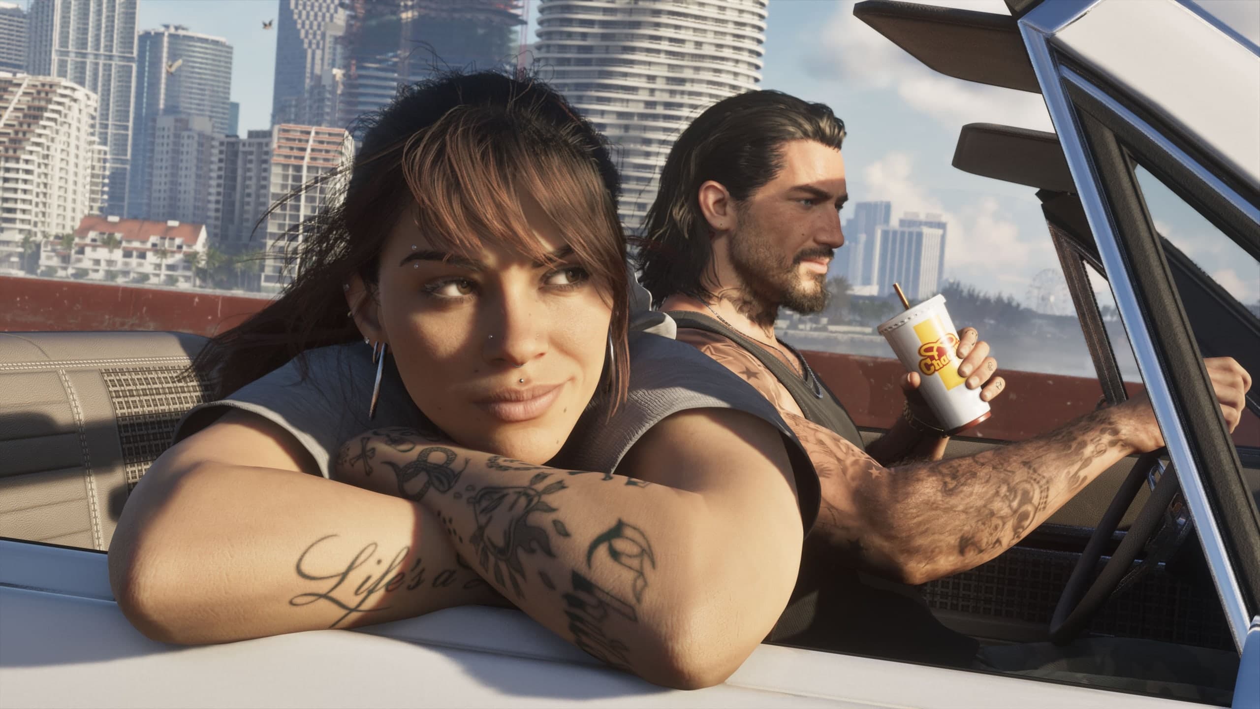 Imagen oficial de Grand Theft Auto VI de Lucía y Jason en un convertible con Vice City detrás.
