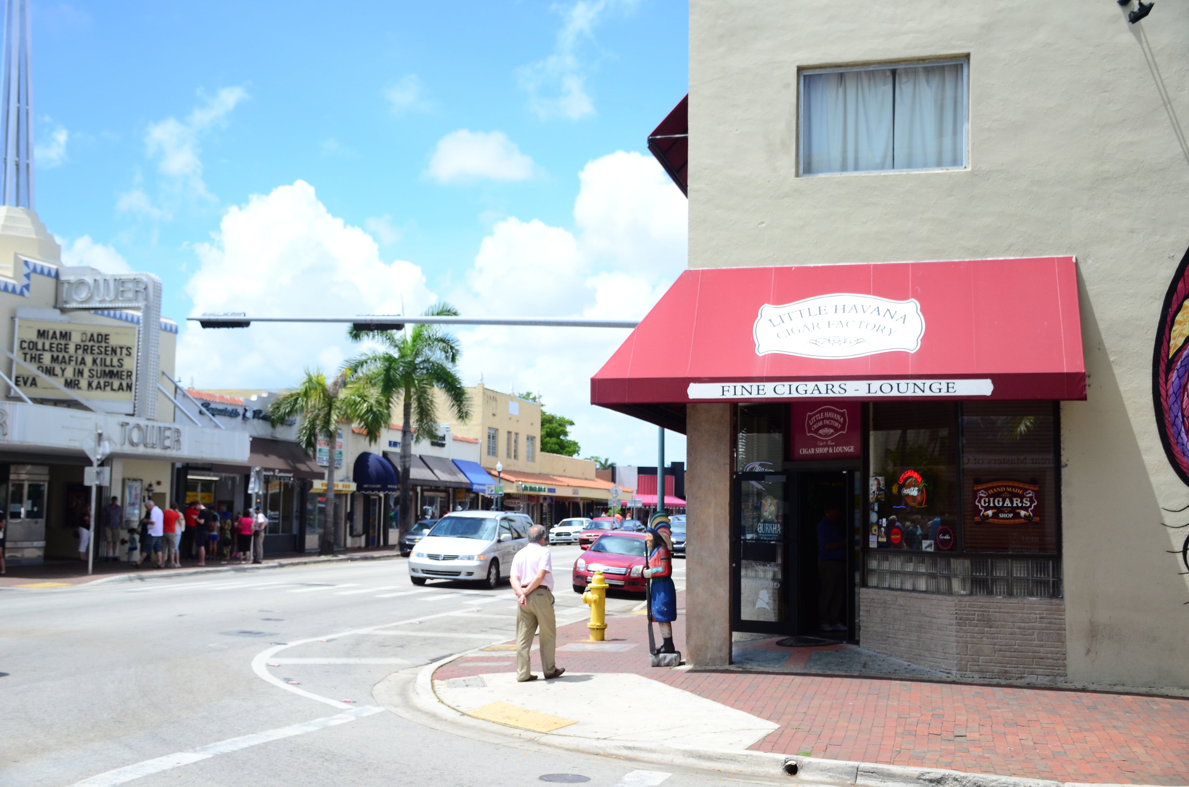 Calle Ocho in Little Havana, Miami, with the Tower Theater and a cigar shop.